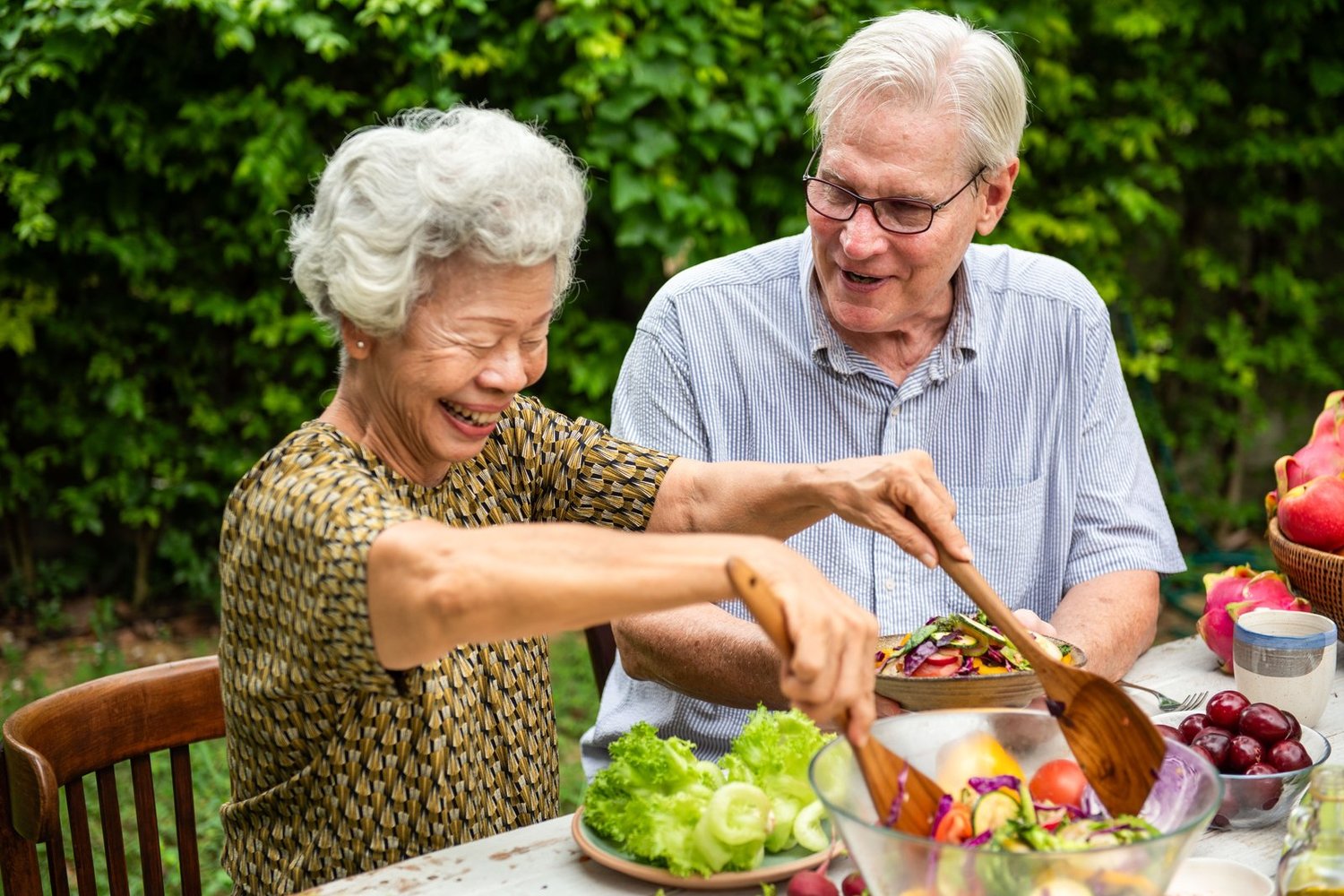An older couple sharing a fresh meal together outdoors
