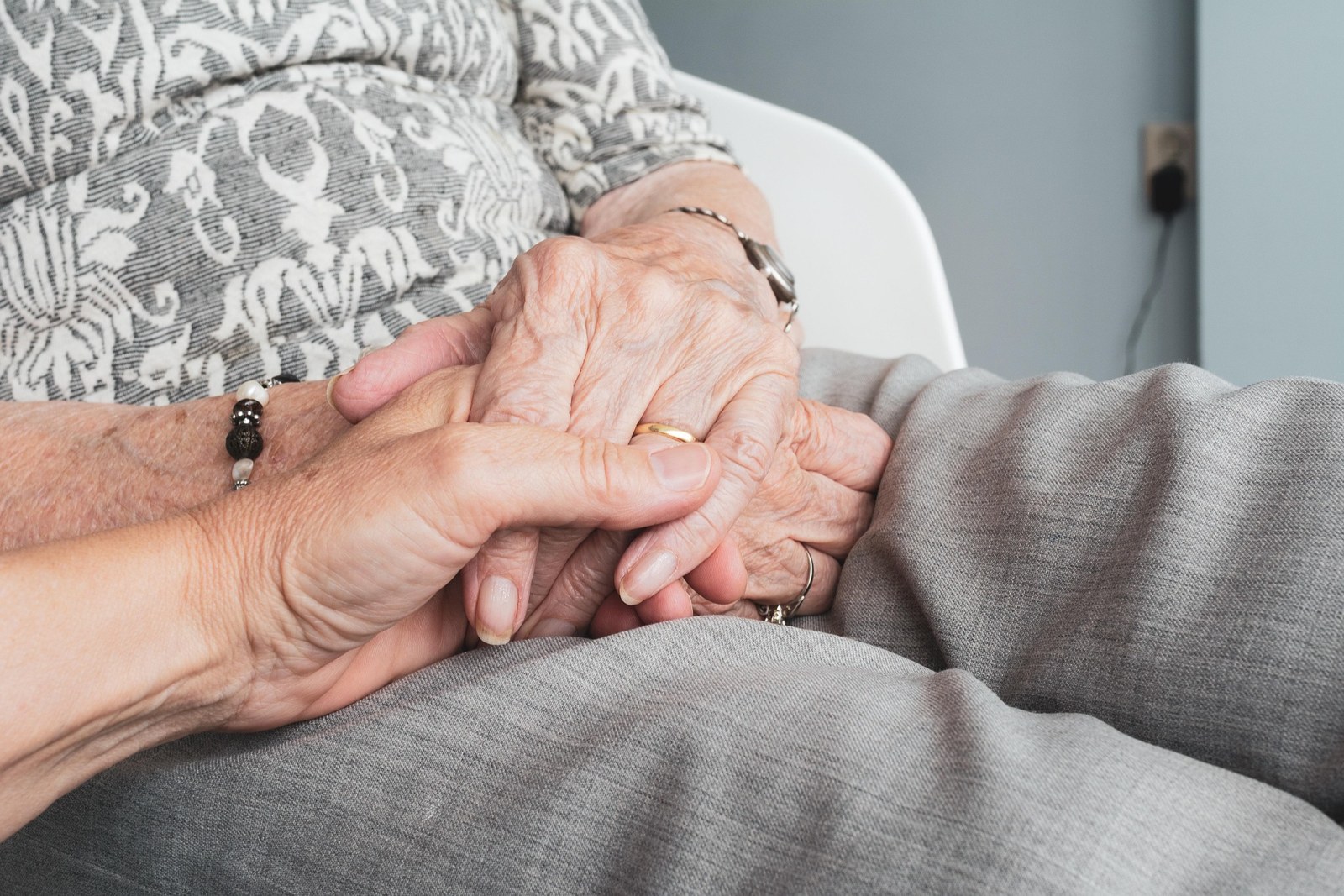 A carer holding an older person's hands